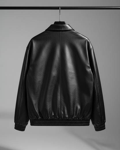 Black leather bomber jacket on hanger - back view