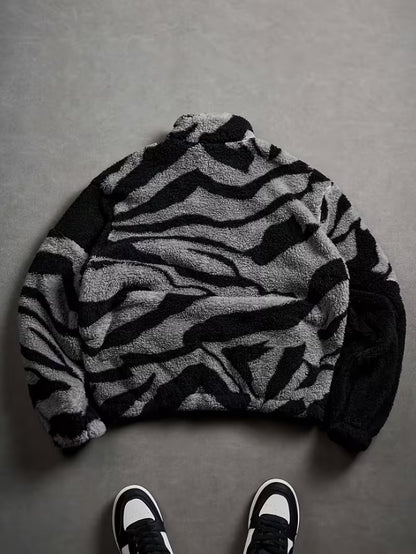lack Plush Jacket with a Zip-Up Collar And Double Pockets, Featuring a Striking Zebra Pattern.